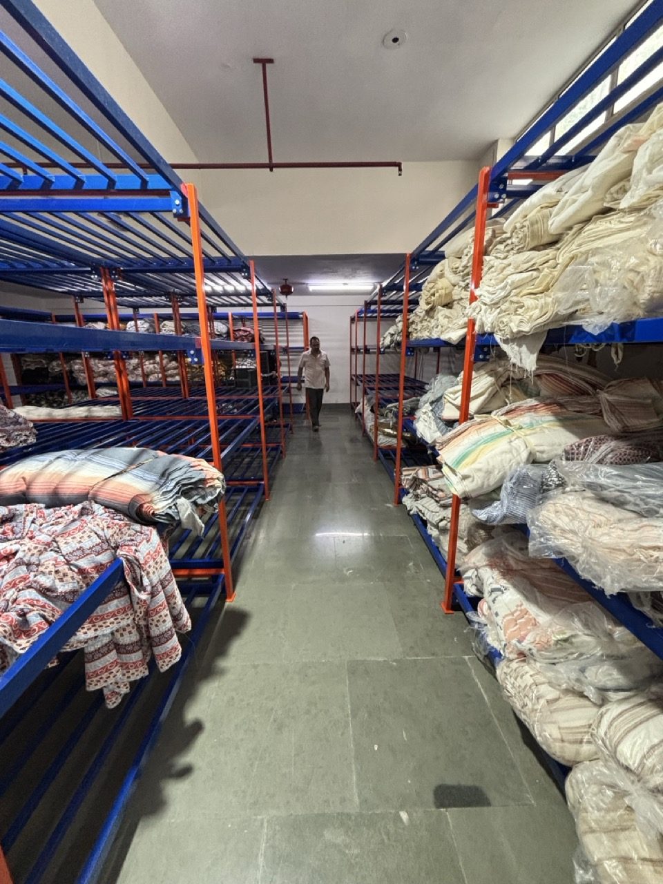 Fabric store holding mill-sourced rolls at Myra Enterprises, Noida