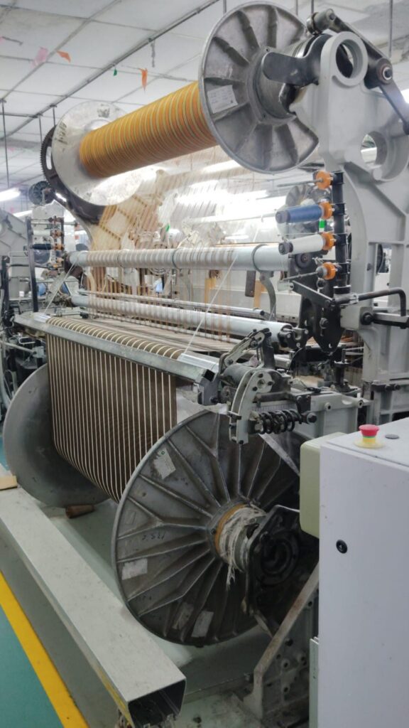 Close detail of jacquard fabric being woven for Myra Enterprises, Noida