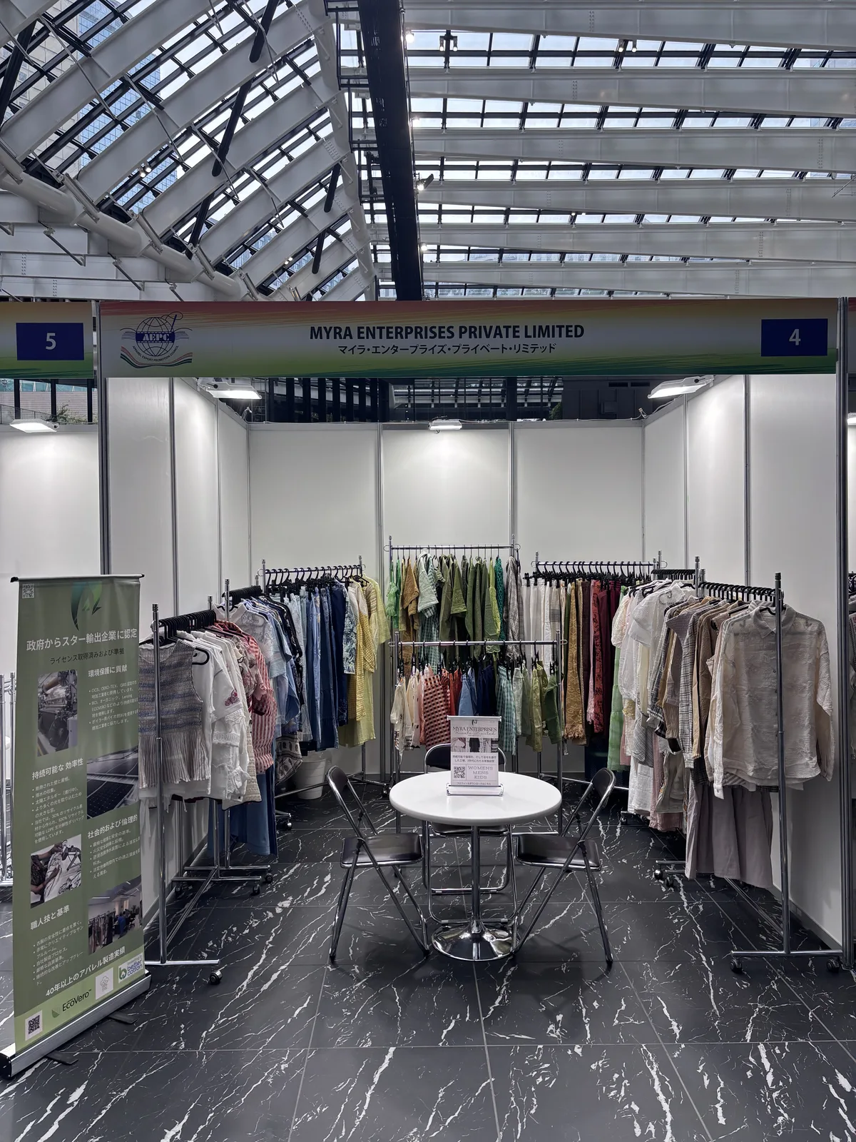 Myra Enterprises stand with womenswear rails and buyer table, Tokyo 2026