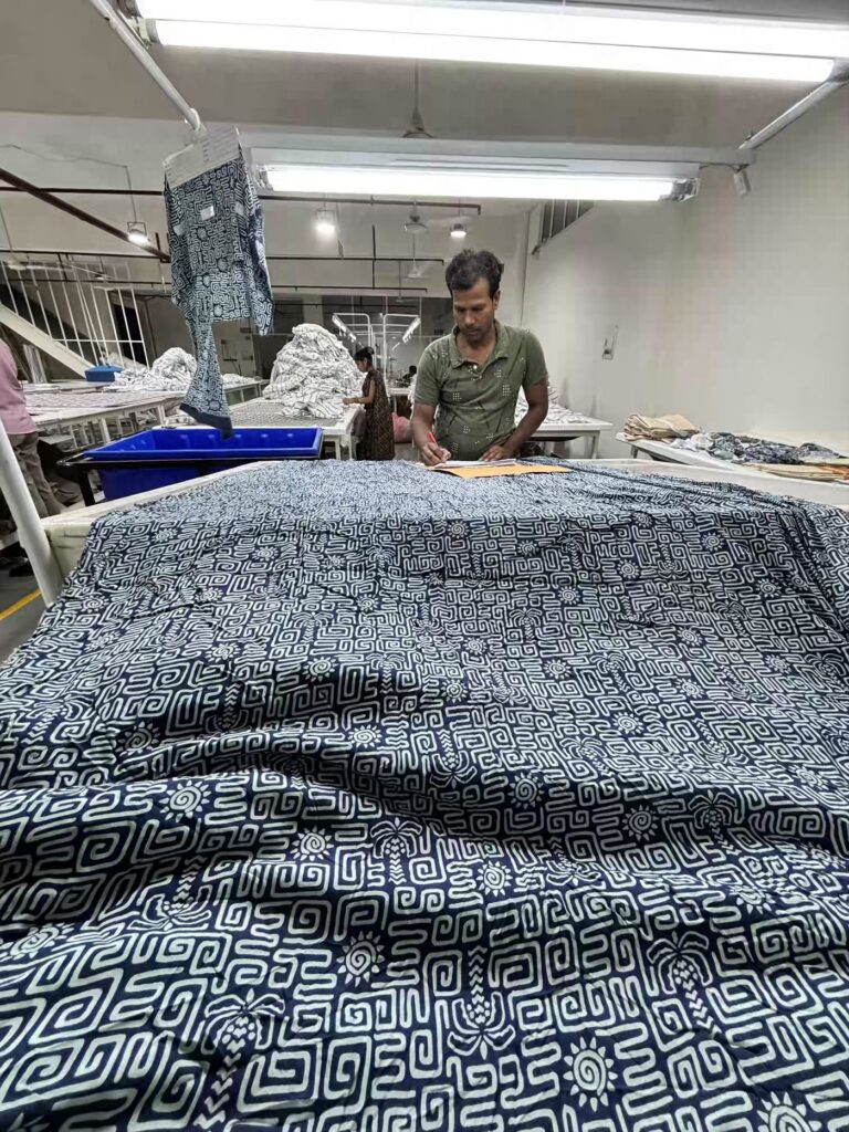 Printed fabric inspected for shade and print quality at Myra Enterprises